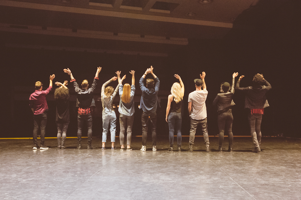 Group of people standing on stage